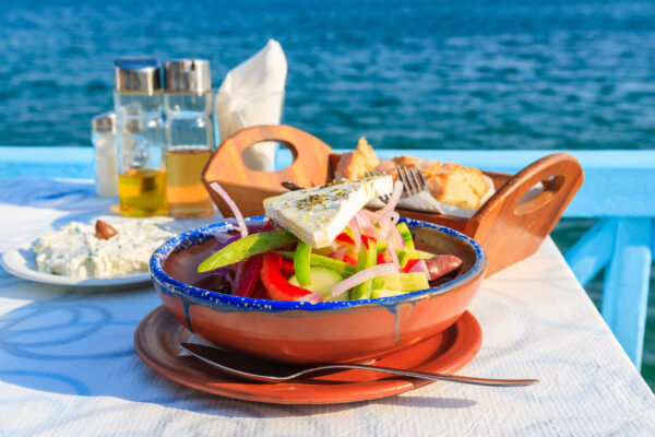 Greek,Salad,On,Table,In,Greek,Tavern,With,Blue,Sea