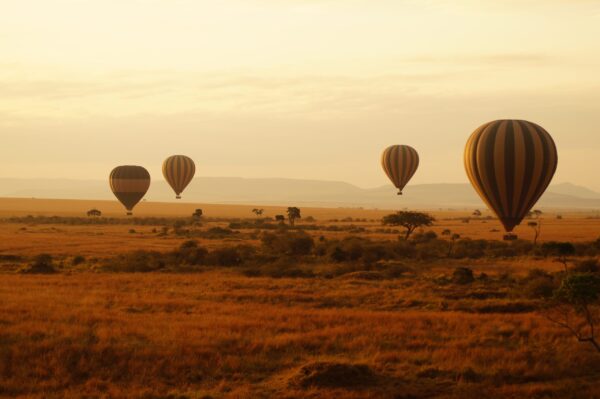Air,Balloons,During,Sunrise,Above,Masai,Mara,In,Kenya.