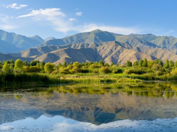 A,Quiet,Mountain,Lake,Issyk-kul,,Surrounded,By,Green,Valleys,And